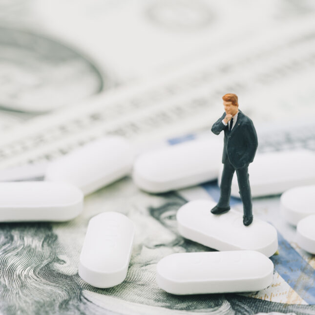 Photo illustration of businessman, pills, and money