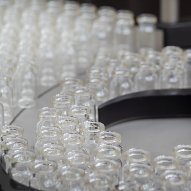 photo of empty glass vials on a production line. -- first opinion coverage from STAT