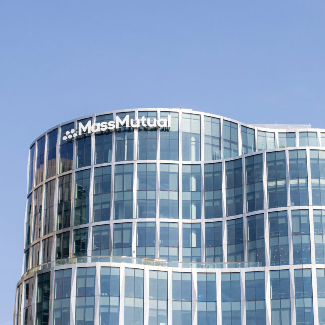 A glass office building of MassMutual with its sign on the top left — insurance coverage from STAT