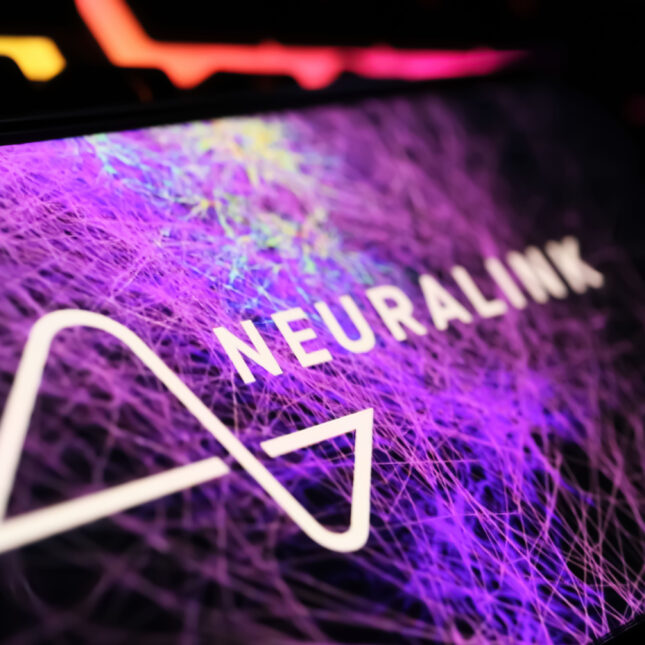 A Neuralink logo on a smartphone in front of a background filled with purple network — first opinion coverage from STAT