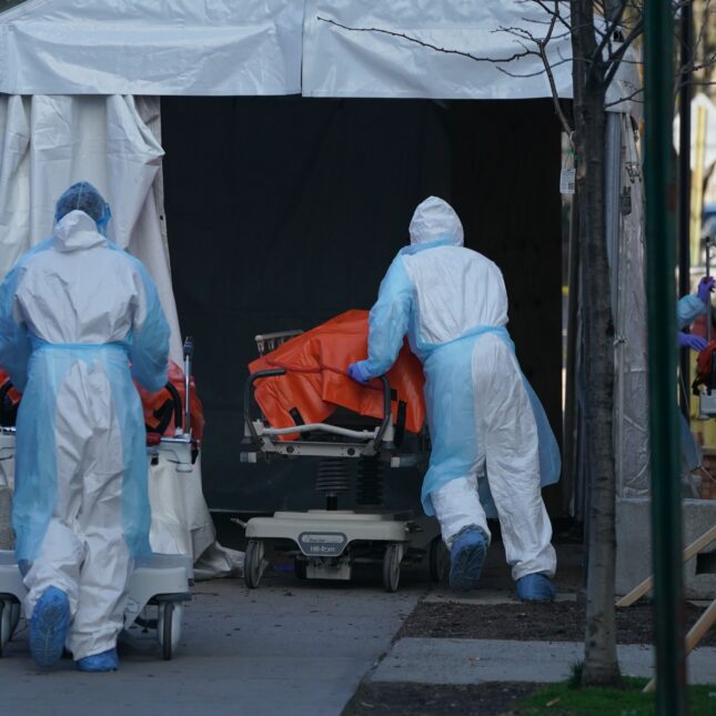 File news photo of Bodies are moved to a refrigerator truck serving as a temporary morgue outside of Wyckoff Hospital in the Borough of Brooklyn on April 4, 2020 in New York