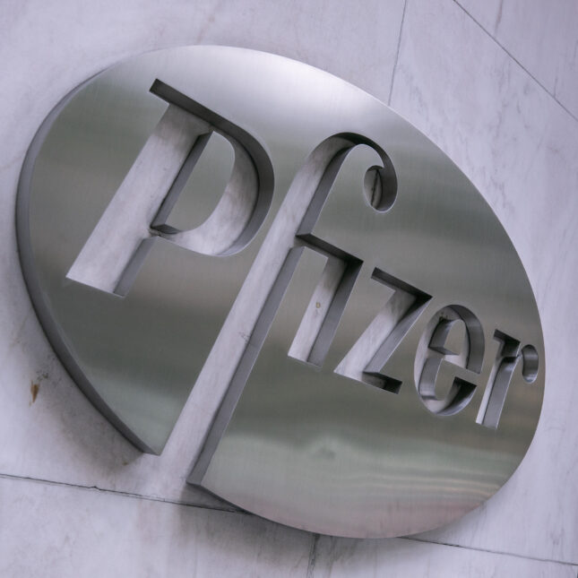 Silver Pfizer Inc. signage displayed on the side of a building. -- biotech coverage from STAT