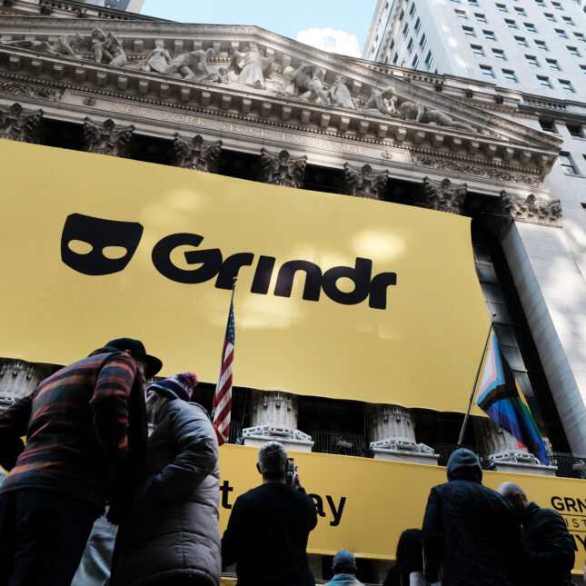 A yellow cloth with the black logo of Grindr, a LGBTQ social networking platform, hangs outside the building of New York Stock Exchange in front of its six columns — politics coverage from STAT