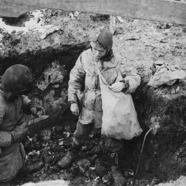 An historical black and white photograph of the famine in Holodomor, Ukraine in 1934. Two boys have found some potatoes that were hidden.