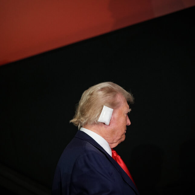 Profile of Donald Trump with a bandaged ear against a red and black background. -- health coverage from STAT