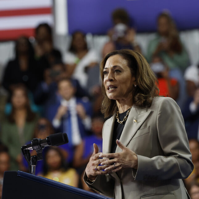 U.S. Vice President Kamala Harris speaks on a podium where the background includes the audiences and the stripes of an American flag — politics coverage from STAT