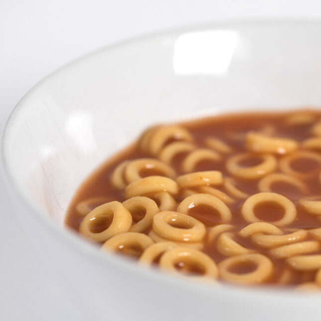 Close up photograph of canned pasta in a white bowl to illustrate ultra-processed foods.